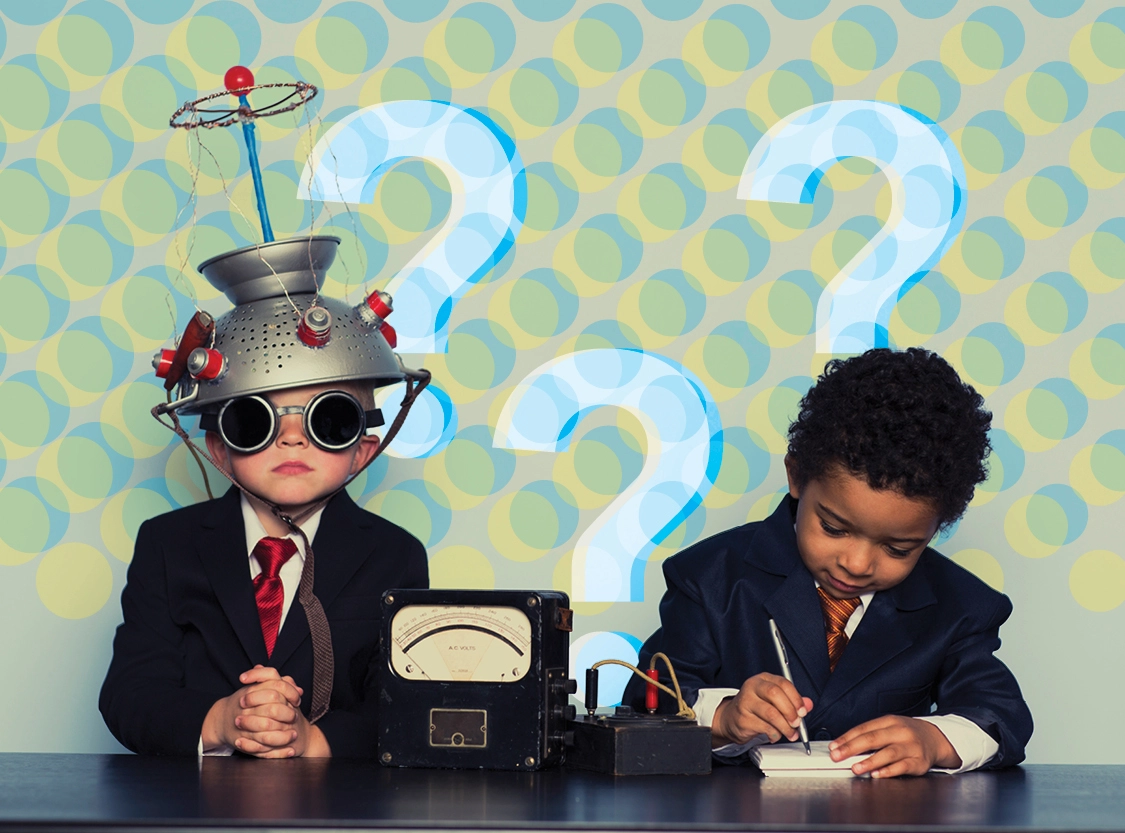Two young students dressed as scientists exploring complex ideas with experimental equipment and question marks in the background.